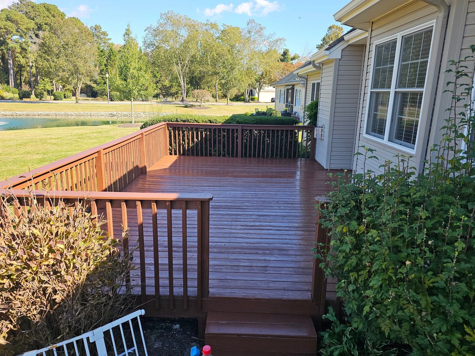 Wood deck with railing built onto the back of a home