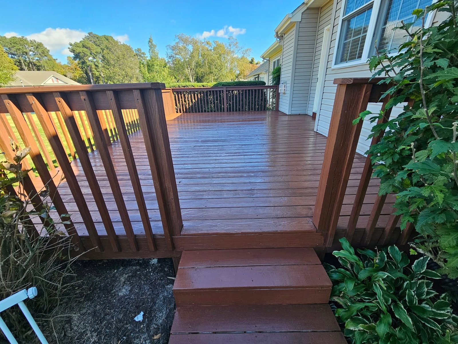 Wood deck with railing attached to a house exterior