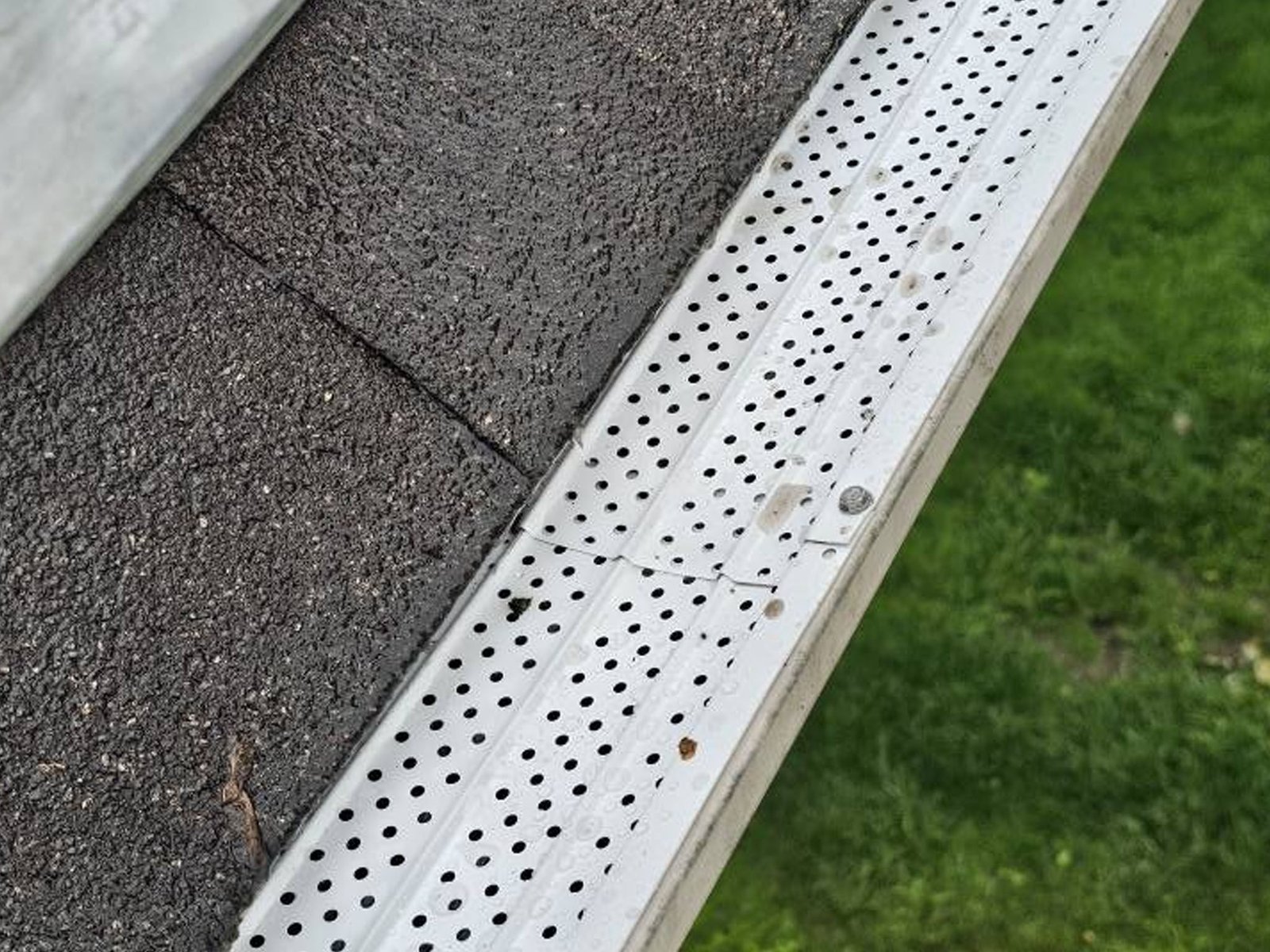 Clean white gutter with gutter guard installed