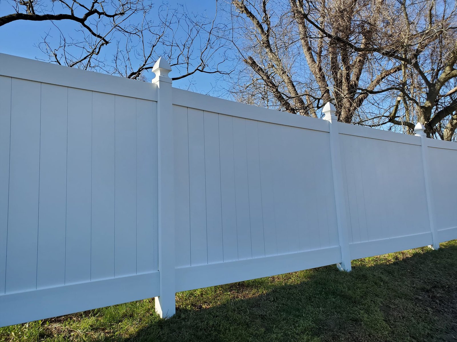 New white vinyl privacy fence installation
